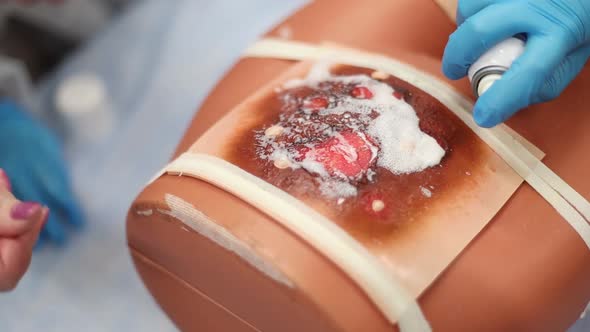 Medical Students Learn to Treat a Burn on a Mannequin