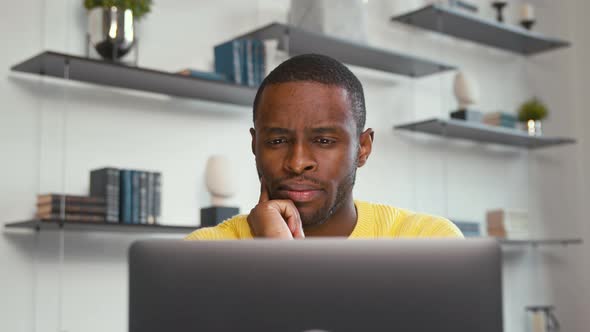 Young man came up with an idea while sitting at work in a laptop at home alt