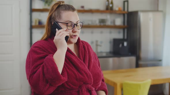 Portrait of Overweight Happy Woman Talking with Friend on Mobile Phone and Smiling alt