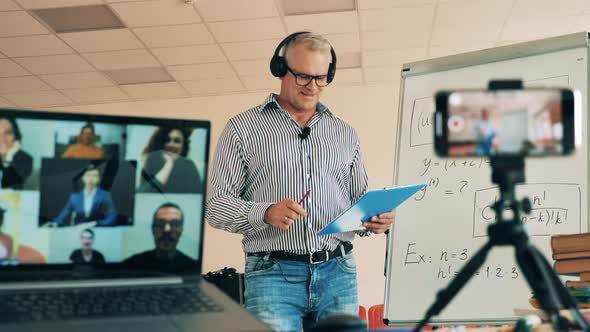 Male Teacher Is Performing an Online Class for a Group of Adults. Online Learning, Online Training alt