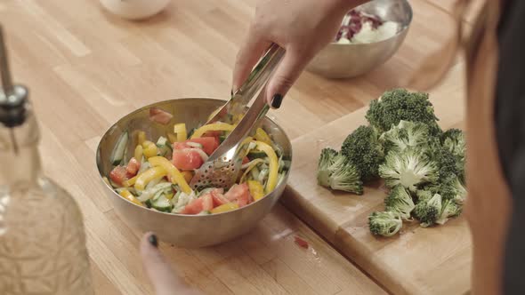 Mixing Fresh Veggie Salad in Bowl alt