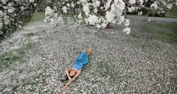 Woman in Blooming Apple Trees