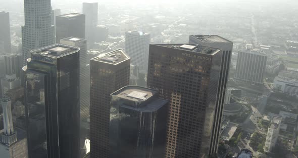 Helicopter aerial tracking shot over California coastline, passing by pier, foggy day alt