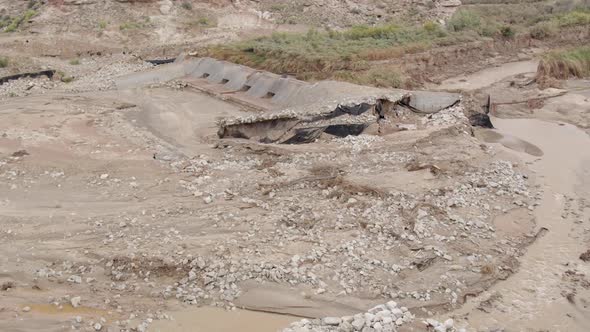 Panning view after flood from heavy rains washing out river banks alt