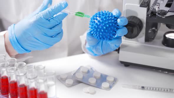 A Scientist in the Laboratory Holds a 2019nCoV Coronavirus Model alt