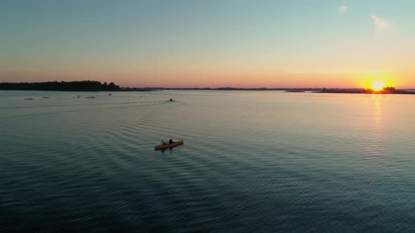 Aerial Drone Footage. Tourists Are Kayaking. Beautiful Sunrise Over River