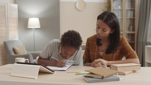 Proud Mom Helping Child with Homework, Stock Footage | VideoHive