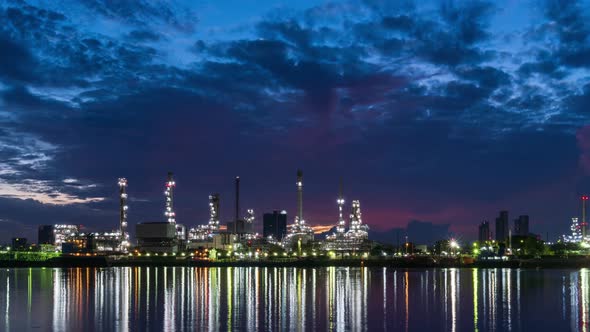 Oil refinery petrochemical and energy industry during morning sun rise, night to day - Time-lapse