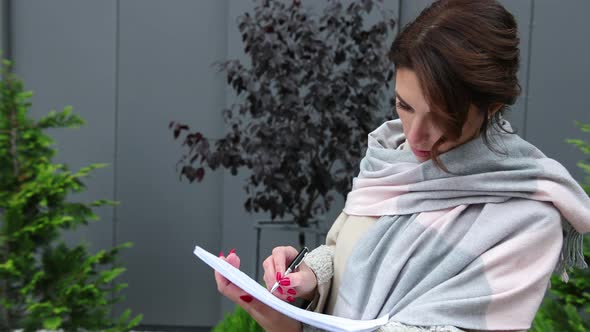 Woman Signing Contract on Clipboard alt