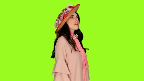 Portrait of Graceful Young Brunette Woman in Pink Dress and Straw Hat Singing Love Song