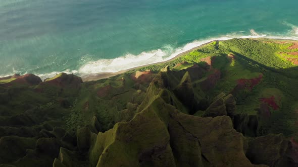 Grassy Rocks of Mountainous Coastal Terrain of Hawaii Illuminated By Sunset Light. Aerial Shot alt