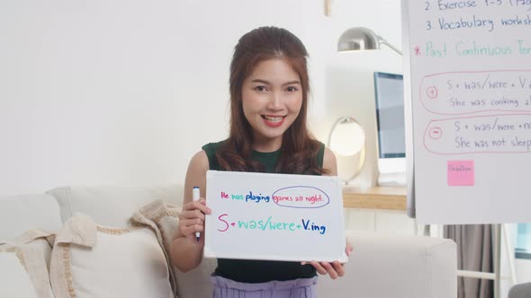 Asia young female english teacher video conference looking at camera talk by webcam.