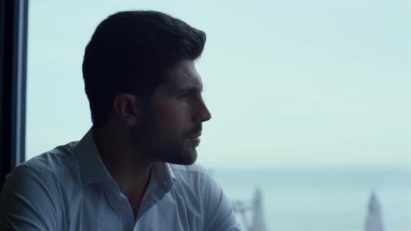 Handsome Man Spending Leisure Time in Dark Panoramic Restaurant Alone Profile alt