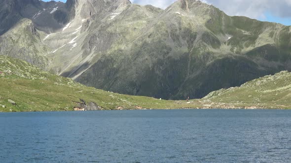 Scenic view on peak of mountains and lake in Swiss Alps