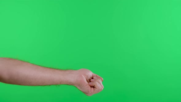 The Woman Measures the Temperature of the Man Against the Background of the Green Screen alt