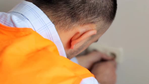The electrician is installing the sockets in the apartment. alt