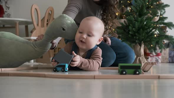 Mom Playing with Her Cute Baby on Christmas Day