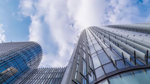 Time lapse of Looking up through the sun roof at office building at clouds and sunshine. alt