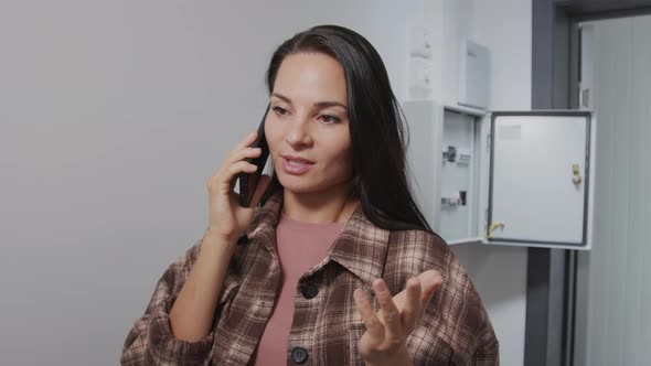 Female Homeowner Calling Electrician alt