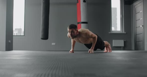 Athlete Performs Fast Pushups on His Fists at the Gym Camera Follows the Movement Workout Training alt