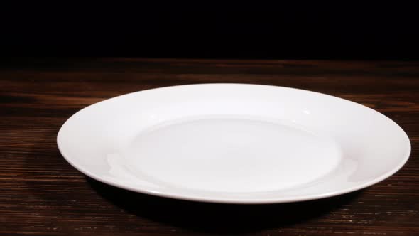 An Appetizing Piece of Grilled Meat Is Placed on a White Plate. Preparing To Serve Pork Steak