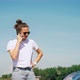 A Young Woman Calls a Help Desk While Standing By the Open Hood of a Car - VideoHive Item for Sale