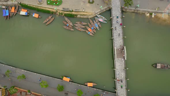 Aerial view of the river that cross the city and the boats in the small city Hot An, Vietnam alt