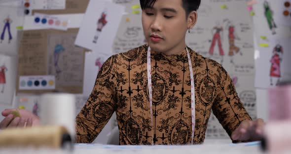 Fucused fashion designer man sewing in studio alt