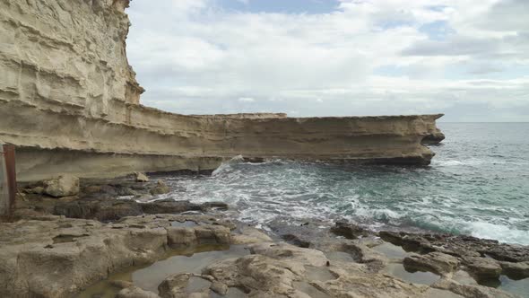 Raging Mediterranean Sea Waves Crashes on St Peters Pool Stone Beach in Malta