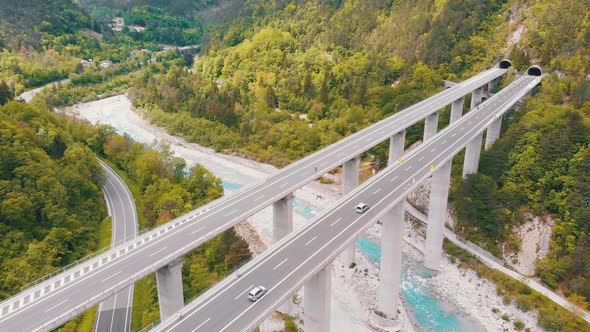 Aerial View of the Concrete Highway Viaduct on Concrete Pillars in the Mountains alt
