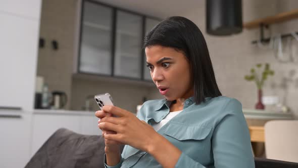 Overjoyed Woman Looking at Phone Screen Celebrating Success alt