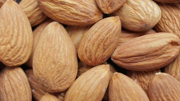 Brown almonds as natural food background or texture.