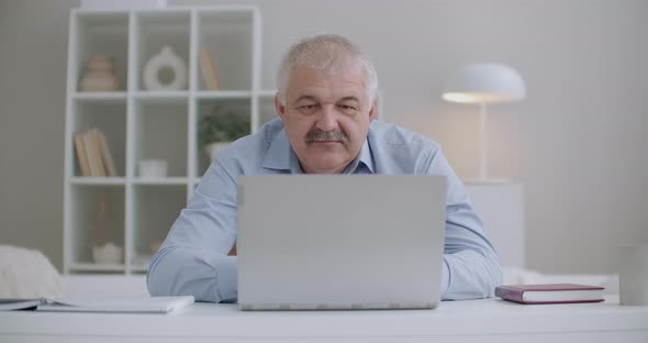 Aged Man with Moustache Is Working with Laptop, Sitting in Room, Answering at Email, Typing Text of alt