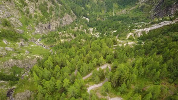 Natural trail in the swiss alps. aerial drone shot . fir trees forest alt