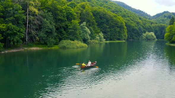 Young Couple in a Boat on the Biogradsko Lake in Montenegro alt