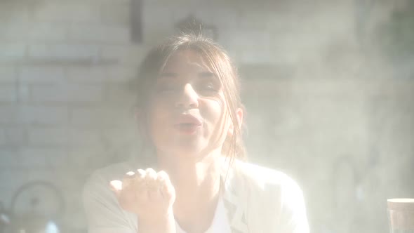 Attractive Young Woman Blow Flour Cloud Right in To the Camera