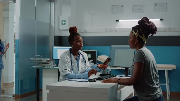 Patient Receiving Bottle of Pills for Treatment Against Sickness alt