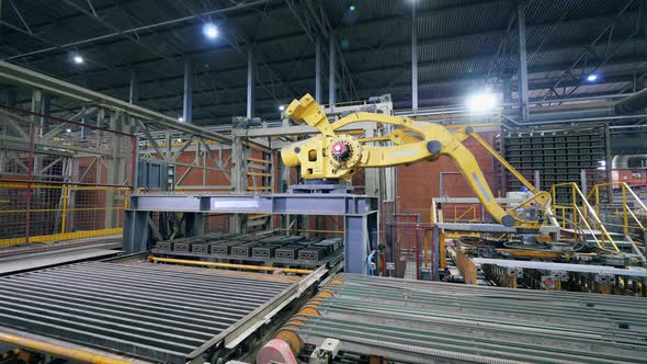Modern Industrial Robotic Arm at a Factory Facility. alt