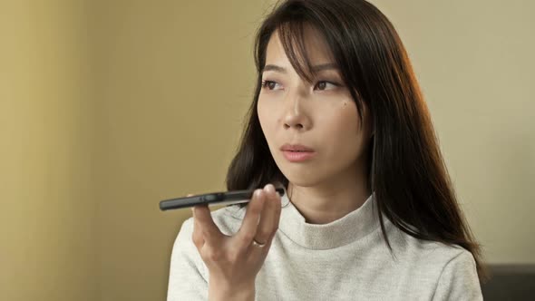Portrait of a Young Asian Woman Talking on a Mobile Phone