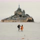 Amazing Cinematic Shot, Drone Follows Happy Couple Hold Hands Walking Towards Epic Mont Saint Michel - VideoHive Item for Sale