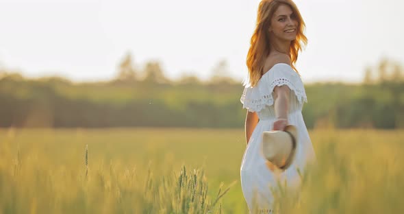 Beautiful Girl in White Dress Whirls in the Summer Field alt