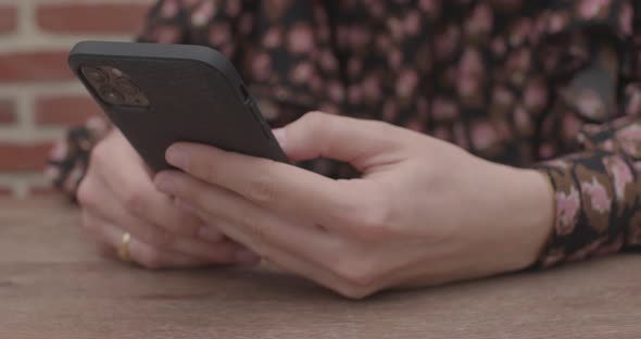 Close Up of Women's Hands Holding Cell Telephone with Blank Copy Space Scree for Text Message or alt