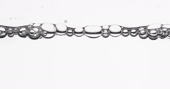 Bubbles In A Row Moving And Popping Along Water Surface alt