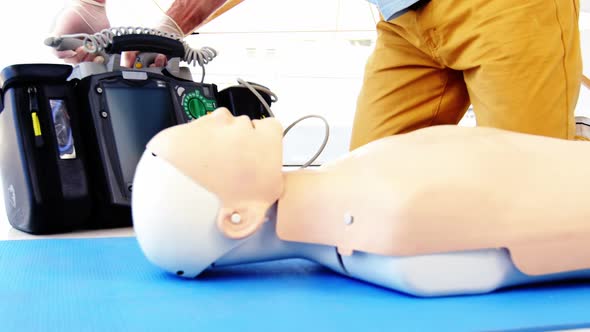 Male paramedic during cardiopulmonary resuscitation training alt