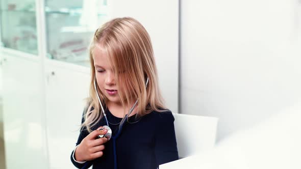 Beautiful Kid Girl Listens To Her Breath and Heartbeat Through Steascope alt