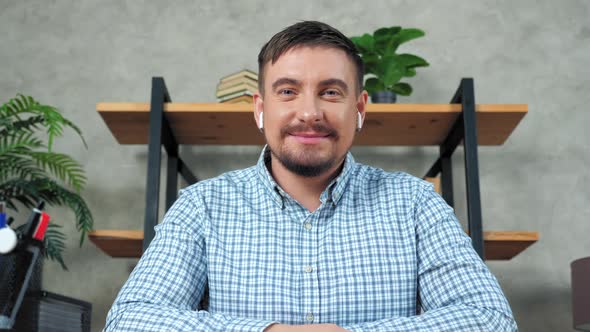 Webcam view businessman greets looks camera listen employees online video call alt