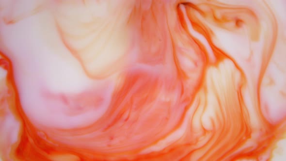  Footage. Ink in Water. Red and Orange Ink Reacting in Water Creating Abstract Background.