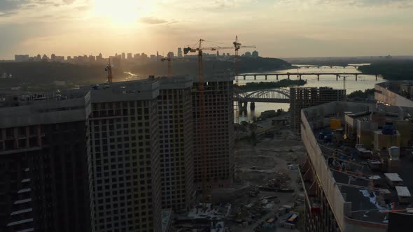 Top Aerial View of Building Construction Site in City at Sunset alt