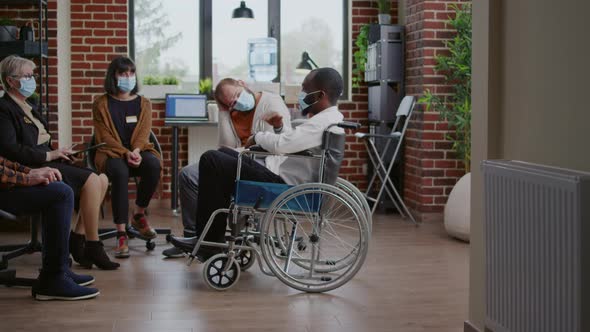 Man Sitting in Wheelchair and Talking About Addiction at Aa Meeting Attending Therapy Session alt