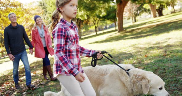 family walking with dog outdoors alt